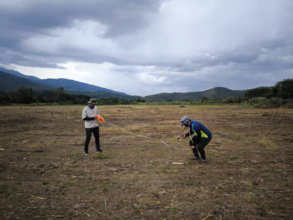 May be an image of 2 people and grass