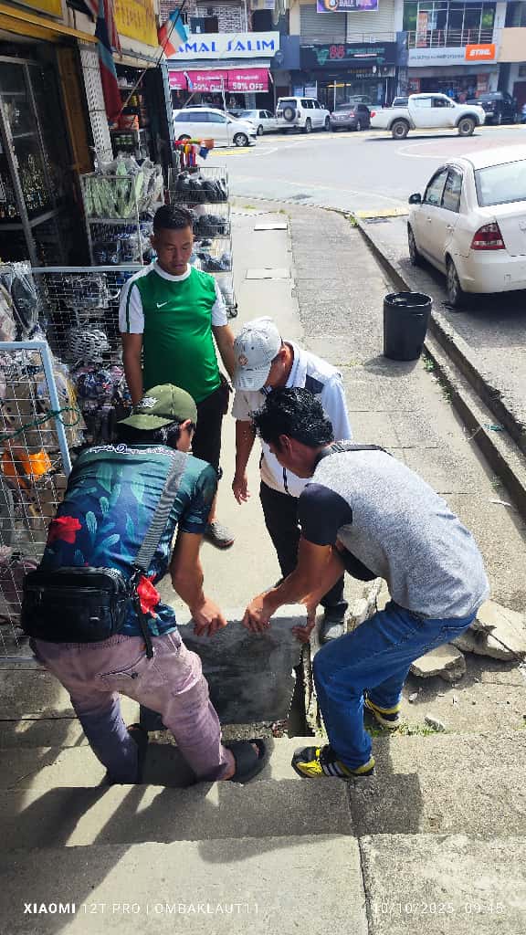 May be an image of one or more people, street and text